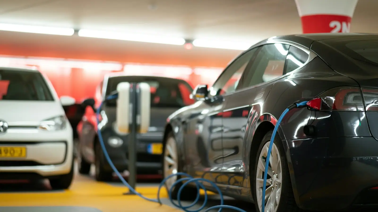 Electric cars charging in a parking garage