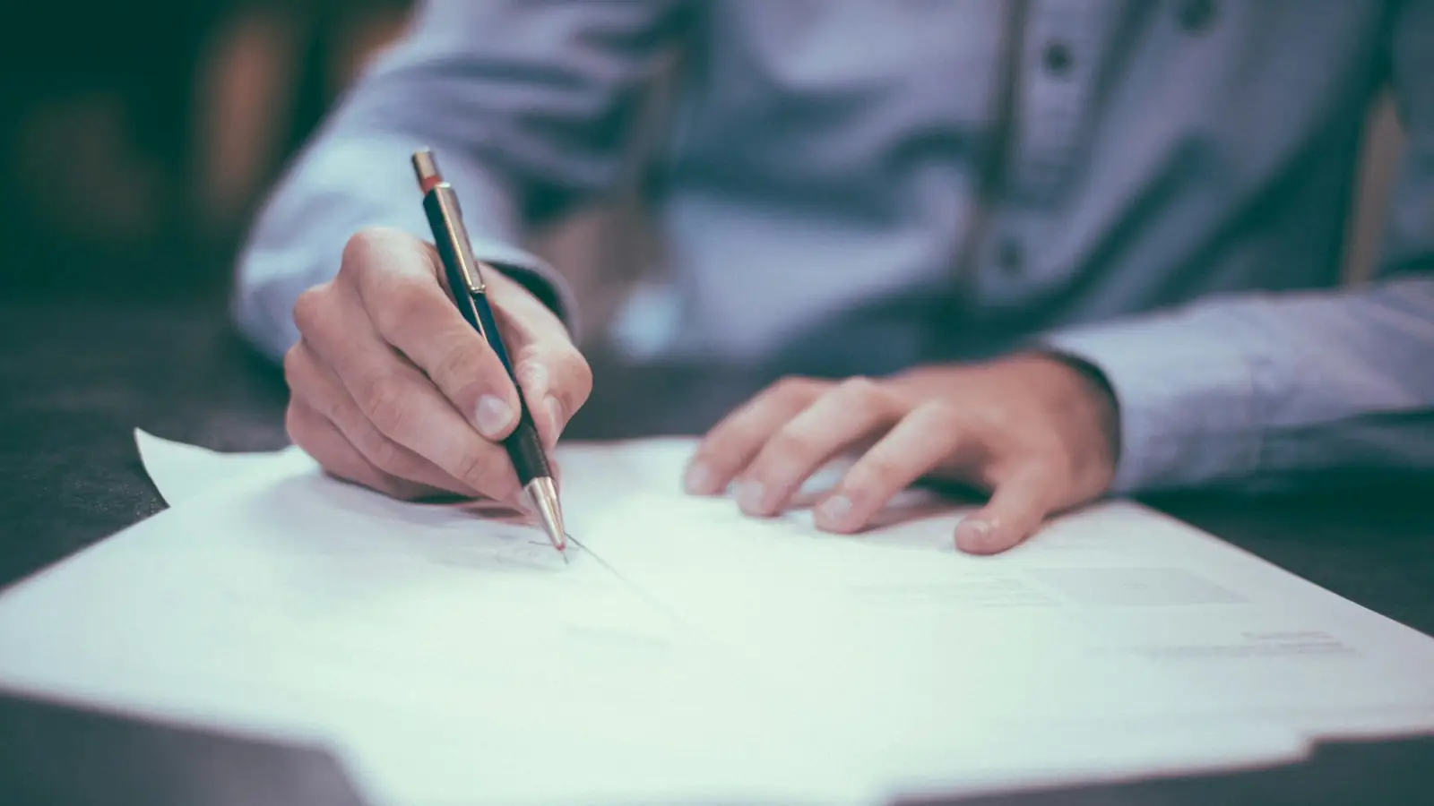 Person signing an insurance policy document