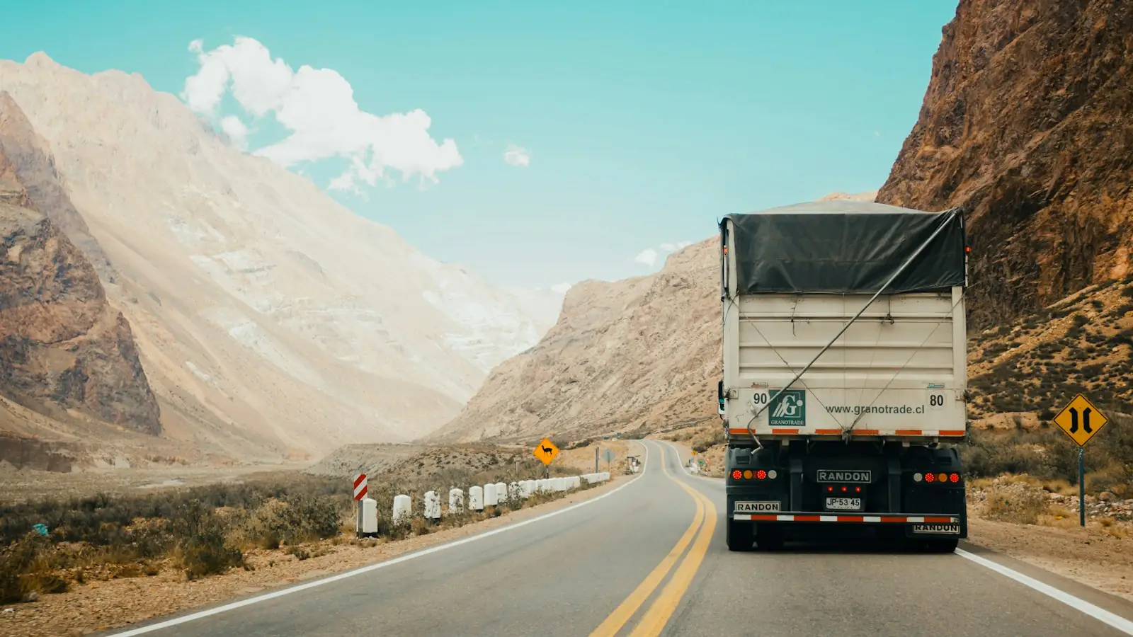 Freight truck driving along a mountain highway