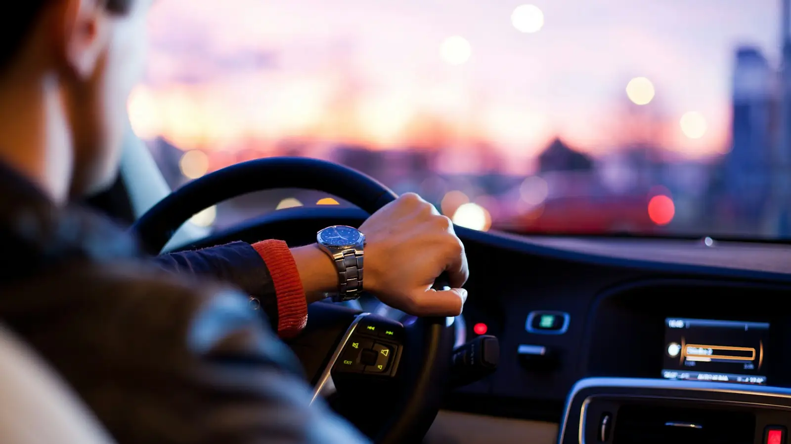 Driver's hands on the steering wheel of a vehicle