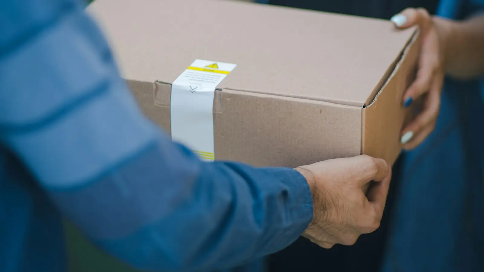 Courier handing a parcel to a customer