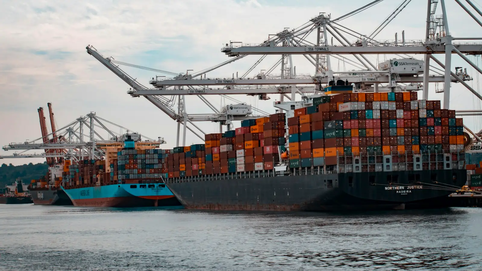 Container ship being loaded at a busy port