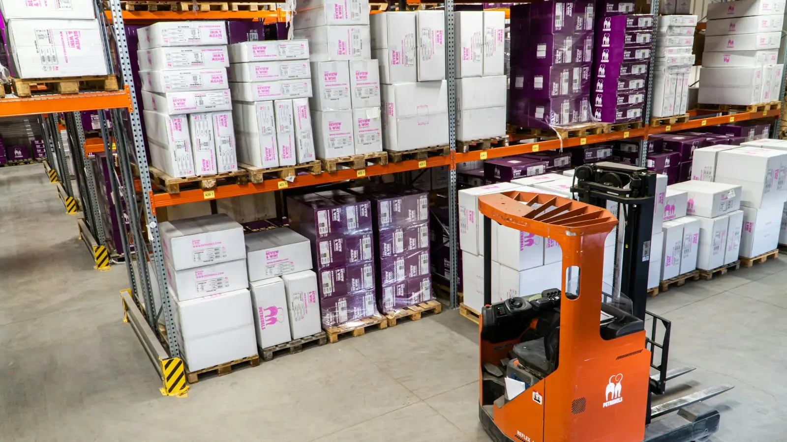 Warehouse shelving with a forklift and stacked boxes