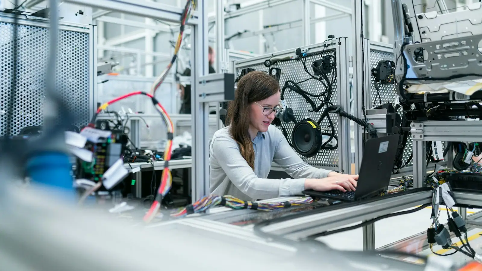 Engineer working at automated manufacturing equipment