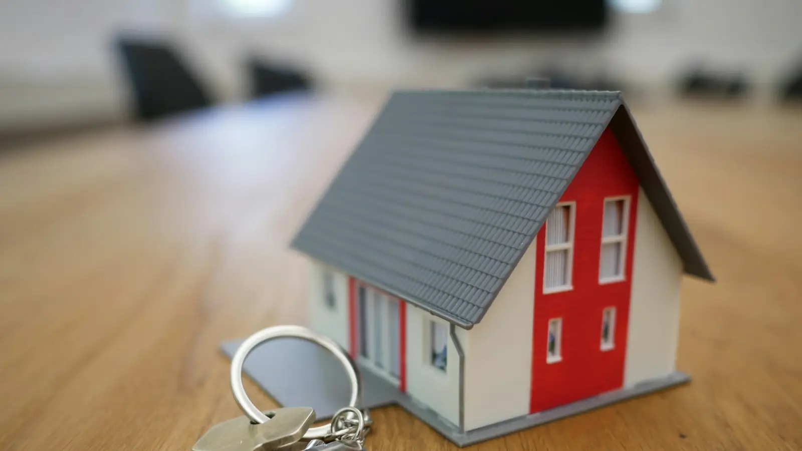 Model house with a set of keys on a table
