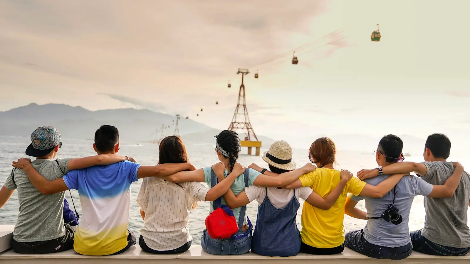 Group of friends sitting together with arms around each other