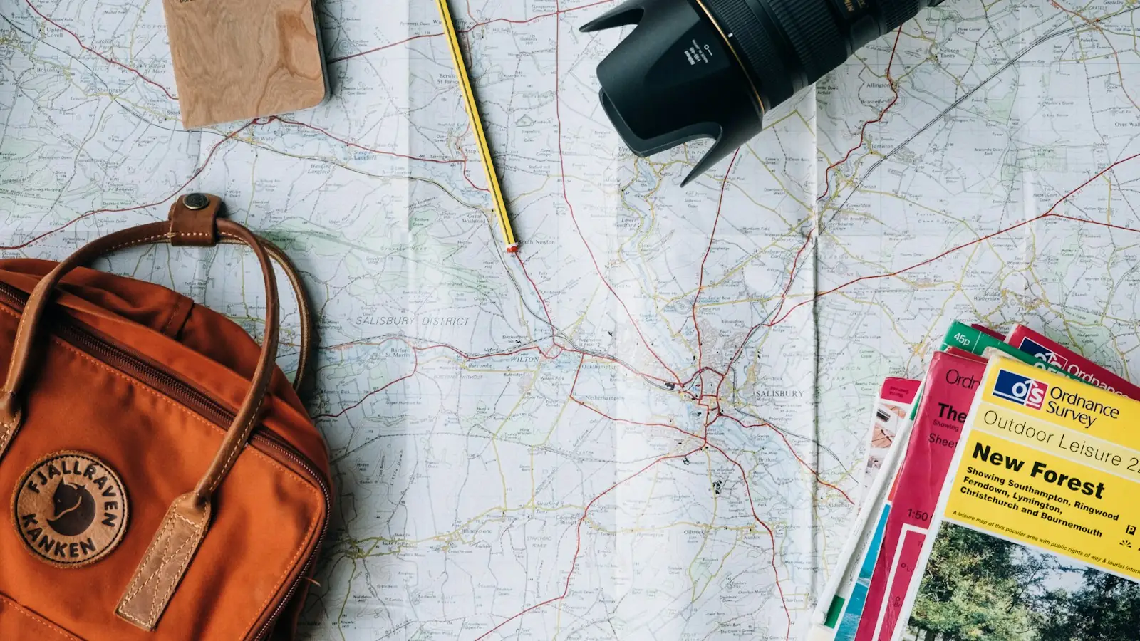 Travel map with a backpack and camera